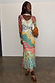 Pastel Morocco Mesh Vivi Dress featuring multi-coloured block prints with sun, eye and palm motifs on a model.
