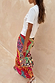 Morocco Beaded Bag with hand beaded abstract patterns and silver accents, styled with a matching colourful maxi skirt.