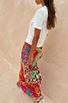 Morocco Beaded Bag with hand beaded abstract patterns and silver accents, styled with a matching colourful maxi skirt.