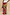 Thumbnail for Morocco Beaded Bag with hand-beaded abstract motifs, held by a model wearing a matching vibrant printed maxi skirt.