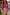Thumbnail for Two-tone blue and red Holly Cardigan with sun motifs, paired with a tan suede mini Jaspre skirt.