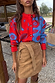 Two-tone blue and red Holly Cardigan with sun motifs, paired with a tan suede mini Jaspre skirt.
