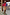 Thumbnail for Blue and Red Holly Cardigan with iconic NFD motifs and contrast knit, paired with a tan suede mini skirt and boots.