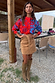 Blue and Red Holly Cardigan with iconic NFD motifs and contrast knit, paired with a tan suede mini skirt and boots.