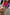 Thumbnail for Blue and Red Holly Cardigan featuring iconic motifs, styled with a tan suede mini skirt and tall boots.