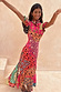 Morocco Remi Dress in a vibrant multi-colour patchwork print with a ruffled high neck and asymmetric skirt.