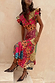 Morocco Remi Dress in a vibrant abstract patchwork print with pleated frill sleeves and an asymmetrical skirt.