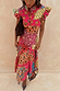 Morocco Remi Dress featuring a watercolour patchwork sun print with a pleated frill neckline and an a-symmetrical hem.