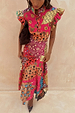 Morocco Remi Dress featuring a watercolour patchwork sun print with a pleated frill neckline and an a-symmetrical hem.
