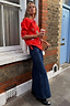 Thumbnail for Red Mystical Cardigan with jacquard motifs and blanket stitch detail, styled with wide-leg jeans for a London street look.