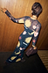 Black Mystical Mesh Dress featuring celestial sun and heart prints, styled with a slip against a wooden wall.