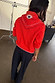 Red Mystical Knit Bandana with an embroidered eye motif and gold details, styled over a red jumper from behind.