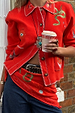 Red Mystical Knit Bandana featuring eye motifs, tied around the waist and paired with a matching red cardigan.