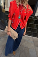 Red Mystical Knit Bandana with iconic eye and snake motifs, draped over shoulders in a street style look.