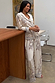 Cream Octopus Button Through Pyjamas in a relaxed fit with contrast piping, worn by a model holding a mug.