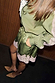 Olive green satin shorts with a pink lace hem and drawstring waist, styled with a matching olive shirt.