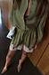 Olive green satin shorts featuring a pink lace hem and drawstring waist, styled with a matching shirt.