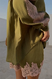 Olive green satin shorts featuring a contrast pink lace hem, styled with the matching lace-trimmed shirt.