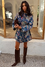 Denim Paisley Belted Shacket in blue with a bold print, cinched at the waist and paired with suede boots.