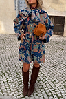 Denim Paisley Belted Shacket in blue with a bright all-over print and cinched waist, styled with brown suede boots.