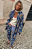 Thumbnail for Blue Denim Paisley Belted Shacket featuring a multi-colour print, styled as a co-ord on a cobblestone street.