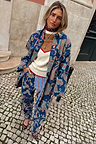 Blue Denim Paisley Belted Shacket featuring a multi-colour print, styled as a co-ord on a cobblestone street.