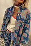 Denim Paisley Belted Shacket in blue with a vibrant multi-coloured print, styled as a coordinated layering piece.