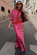 Pink Paisley Dorris Skirt and matching cardigan worn with leopard print heels on a cobblestone street.