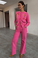 Thumbnail for Pink Denim Scallop Detail Jeans with wide legs and scalloped pockets, worn with a matching pink cardigan.
