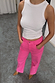 Thumbnail for Pink Denim Scallop Detail Jeans with a wide-leg fit and scalloped pockets, paired with a white ribbed vest.