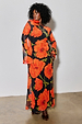 Black Poppy Aria Mesh Dress with a red poppy print and long sleeves on a size 18 model for inclusive sizing.