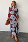Burgundy & Blue Poppy Aria Mesh Dress with a poppy print and sheer long sleeves, styled with brown accessories.