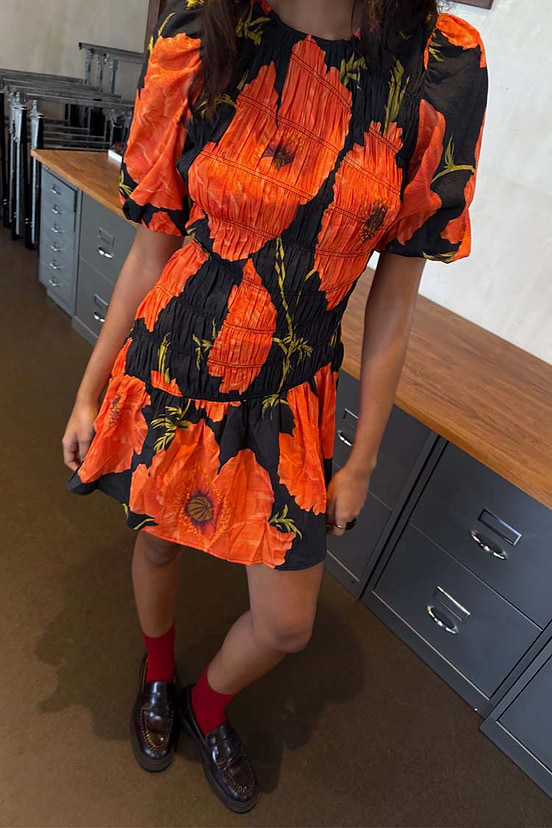 Black Poppy Mini Nara Dress in an iconic poppy print with a shirred bodice and puff sleeves, designed in London.