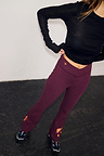 Burgundy cotton flare pants with coral embroidered motifs, designed in London for an effortless gym look.