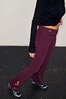 Burgundy cotton wide leg trousers with coral embroidery and a flare silhouette.