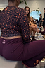 Burgundy wide-leg pants with coral embroidery and NFD logo, styled with a leopard print gym top.