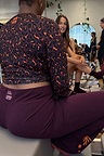 Burgundy wide-leg pants with coral embroidery and NFD logo, styled with a leopard print gym top.