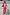 Thumbnail for Pink Bandana Copenhagen Jumper and matching red joggers co-ord, styled with a necktie and silver suitcase.
