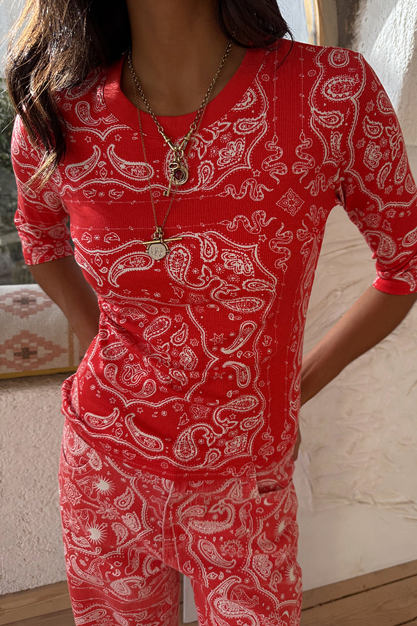 Red Bandana Rib Jersey Top featuring a white paisley print, styled with layered gold necklaces.