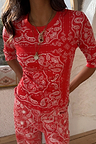 Red Bandana Rib Jersey Top featuring a white paisley print, styled with layered gold necklaces.
