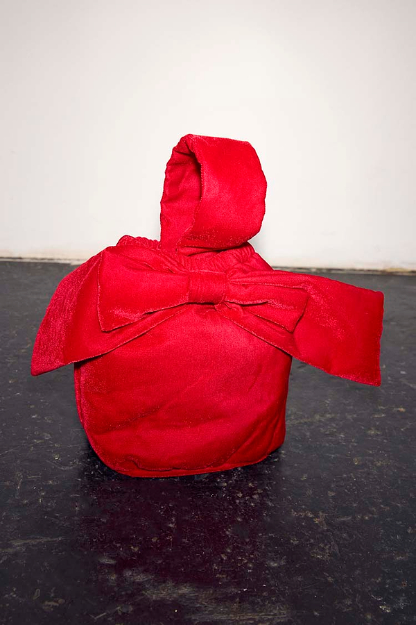 Red Velvet Bow Bag featuring a large bow and top handle, set against a neutral studio backdrop.