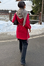 Red Ski Knit Long Cardigan with embroidered motifs and a tie-waist, styled with a scarf in a snowy setting.