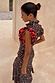 Cherry Leopard Remi midaxi dress with leopard print, red cherry frilled sleeves and a pleated neckline.