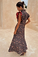 Cherry Leopard Remi Dress featuring red pleated frill sleeves and iconic leopard print, styled with matching heels.