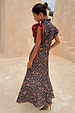 Cherry Leopard Remi Dress featuring red pleated frill sleeves and iconic leopard print, styled with matching heels.