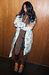 Model wearing the Mono Swallow Romance Reversible Coat with white quilted fabric and black swallow motifs.