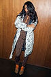 Model wearing the Mono Swallow Romance Reversible Coat with white quilted fabric and black swallow motifs.
