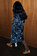 Mono Swallow Romance Reversible Coat with a black and white swallow print, shown on a model walking.
