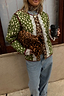 Thumbnail for Reversible quilted jacket in green deer print with leopard accents and white lace trim, styled with denim.