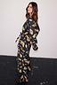Deloris Satin Robe in black featuring gold hand, heart and eye motifs with a waist tie fastening.